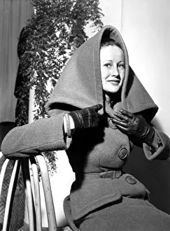00196 Prints: A woman wearing a woollen two piece fabric suit coat with a collar / hood
