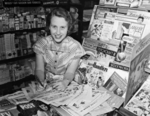 01000 Collection: A woman working in a newsagent in Newport, Isle of Wight. 11th August 1955