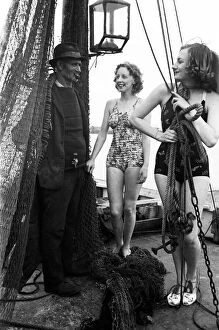 Contrast Collection: Women in their bathing costumes with a fisherman, along the coast, Hastings, circa 1945