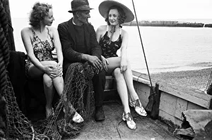 Fisherman Prints: Women in their bathing costumes sitting in a fishing boat with a fisherman