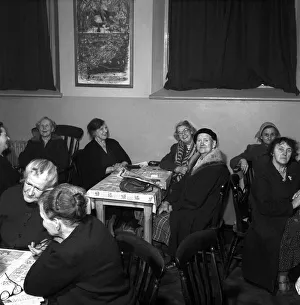 Women chat, share a cup of tea and read the newspapers at a womens lodging house