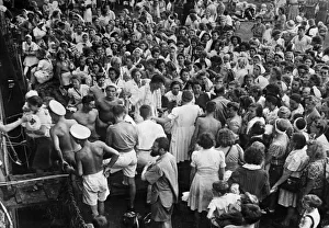 Women and children internees from Surabaya boarding HMS Bulolo, bound for Singapore