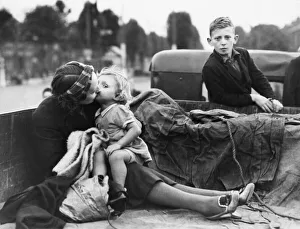 Women and children preparing to evacuate their town before nightfall during Second World