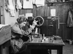 00474 Prints: A women examines the bolts used in the construction of the Miles 3 Falcon aircraft