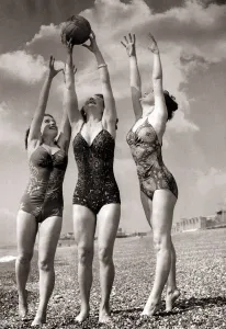 Women Holidaymakers at Hasting making merry with a medicine ball on the beach