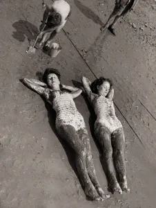 00084 Prints: Women Holidaymakers sunbathing on the wet sand wearing swimming costumes bathing suits
