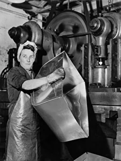 Women in Industry: Girl operates a 60 ton press and turns out pram bodies at one a minute
