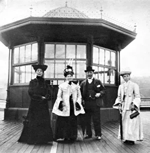 Women and men wearing edwardian fashion during a trip to the seaside at Roker Beach circa