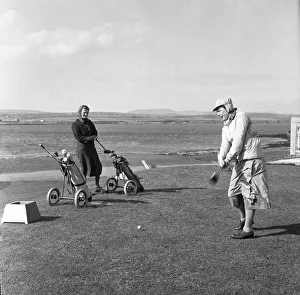 Women playing a round of golf on a very windy Fort Island Golf links Hotel on the Isle of