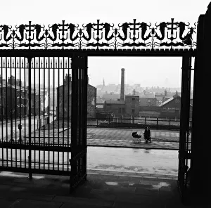 Christian Prints: Two women, one pushing a pram, seen through the gates of Liverpool Anglican Cathedral