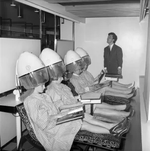 Magazine Prints: Women reading magazines at the John London Hair and Beauty Saloon whilst under the driers