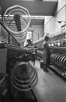 Spinning Prints: Women workers joke whilst overseeing cotton spinning, Miklan, Italy. Circa 1955
