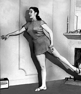 Balancing Prints: Womens Beauty Culture Kelly Bluett demonstrates leg exercises June 1949