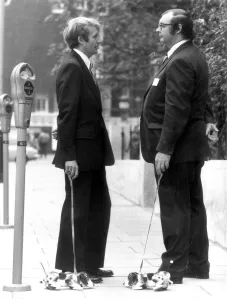 Promoting Prints: Wooden Snoopy Dogs on leads being demonstrated by Managing Directors of the firm that