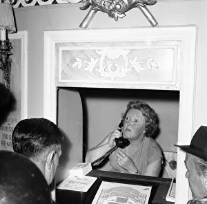 A worker on the telephone at the box office of The Duke of Yorks theatre in the West End
