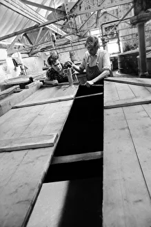 Whisky Prints: Workers inspect the malt grist in the Mash tun at the Knockando Whisky Distillery