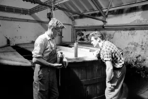 Whisky Prints: Workers inspect the malt grist in the Mash tun at the Knockando Whisky Distillery