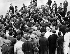 Workers, press men and officials try to get a look at the New Flyweight Champion of