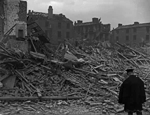 Workers and residents make their way through the shattered remains of Queens Road, Aston