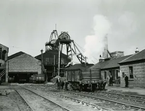 Factories Prints: Worklers pulling along a wagon carrying coal at Priory Colliery in Blantyre