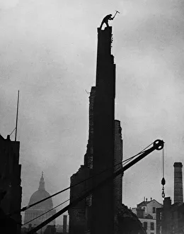 Solitude Prints: Workman James Woods demolishing a chimney stack with his pickaxe in the shadow of St