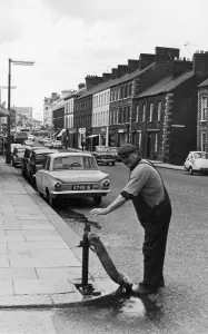 Hosepipe Prints: A workman from the local water board seen here working a standpipe in Portadown