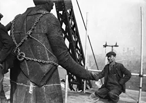 Workman shakes hands'with the statue of William Wilberforce