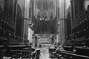 Workmen clear away debris from collapsed Lantern Roof from Westminster Abbey