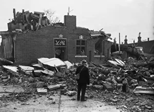 01481 Prints: Workmen clear away the rubble following an air raid on Putney, London