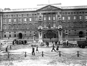 Workmen clear up the rubble outside Buckingham Palace after a daylight raid in 1940