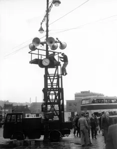 Workmen are erecting the scaffolding for the loud speakers in readiness for