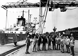 Workmen from Garston Stevedores lifting their hats to the success of their company