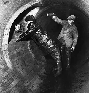 Underground Prints: Workmen inspect the underground sewer tunnel that extends from under the Mersey tunnel