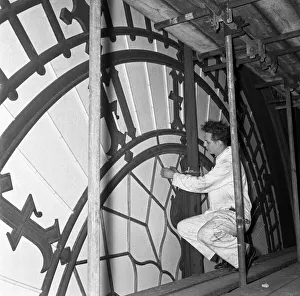 Big Ben Prints: A workmen inspects the minute hand of the clock face of Big Ben during the major overhaul