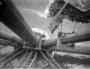 Workmen preparing a platform around one of the girders of the Forth rail Bridge prior to