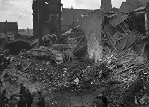 Workmen survey the shattered remains of W. H. Smart in Wrentham Street