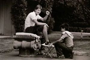Man And Child Prints: World Cup 1986 in Mexico. England striker Gary Lineker gets his boots polished by a