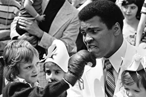 Glove Prints: World heavyweight boxing champion Muhammad Ali presented a sunshine coach on the behalf