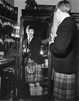 01518 Prints: World Lightweight Champion Ken Buchanan seen here modelling a kilt prior to his trip to
