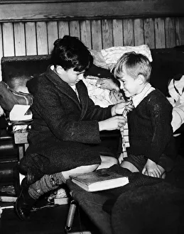 World War Two 1940 Evacuee boy gets a helping hand from his elder brother