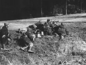Belgian Prints: World War One - Belgian soldiers man a machine gun on the edge of a road as part of