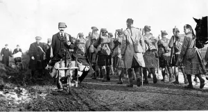 Canadian Prints: World War One - Canadian kilties march at Mons passing French civilians 1918