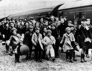 Innocence Prints: World War Two Children evacuated from the cities disembark from a train in the West