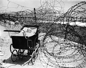 World War II: Home front. Baby enjoys the sea air as best she can