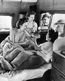 00044 Prints: World War II Women. Three ATS girls who live in a Caravan seen here getting the attention