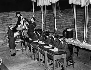 Parachute Prints: World War II Women. A parachute packing class in progress, with the parachutes hanging up