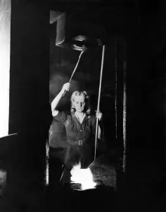 World War II Women. A woman operating a power hammer at the L. N. E. R. loco works