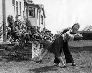 World War II: Women. Women munitions workers dance the jitterbug at a tea dance