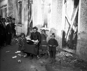 Widow Prints: World War One. Widow and three children outside ruined home in Melle