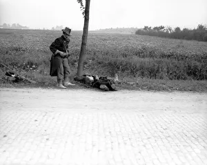 Belgian Prints: World War One. A wounded Belgian soldier falls by the roadside in 1914